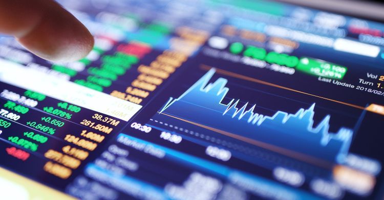 A close-up of a tablet displaying detailed stock market charts and financial data.