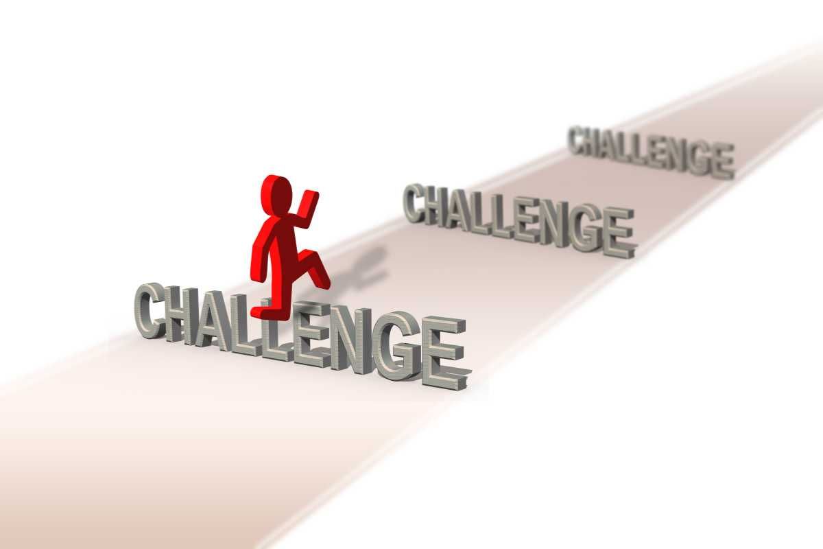 A figure climbing steps formed by the word  CHALLENGE in a 3D perspective