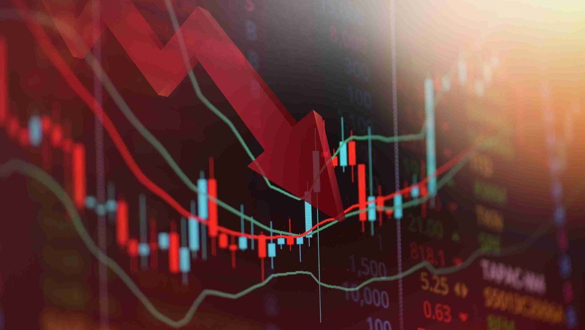 A large red arrow positioned at the centre of a declining stock market