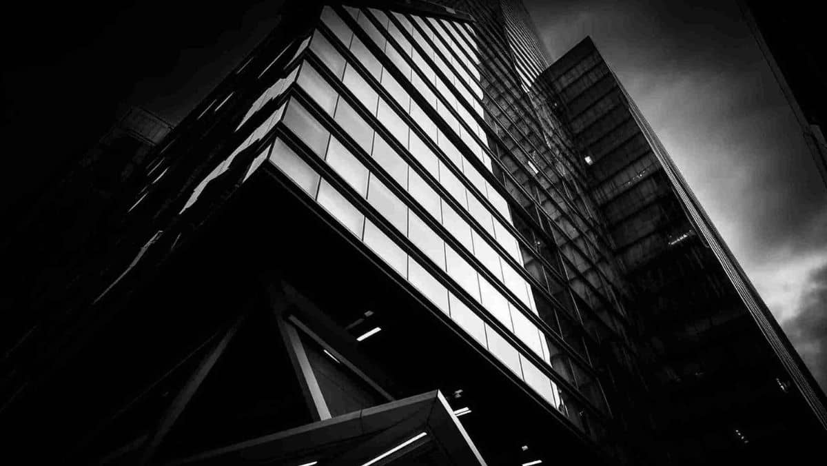A modern skyscraper with a futuristic design characterized by a sleek black exterior