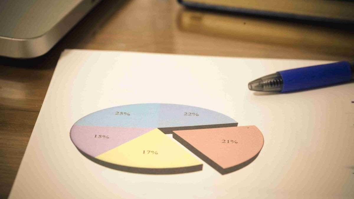 A pen lies on the table alongside a pie chart displaying percentage breakdowns of its components