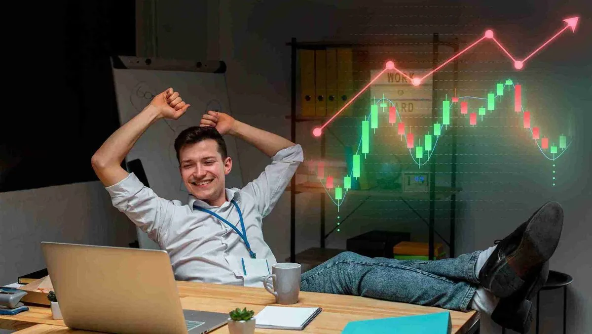 A person sitting comfortably rejoicing while looking at the laptop on the table