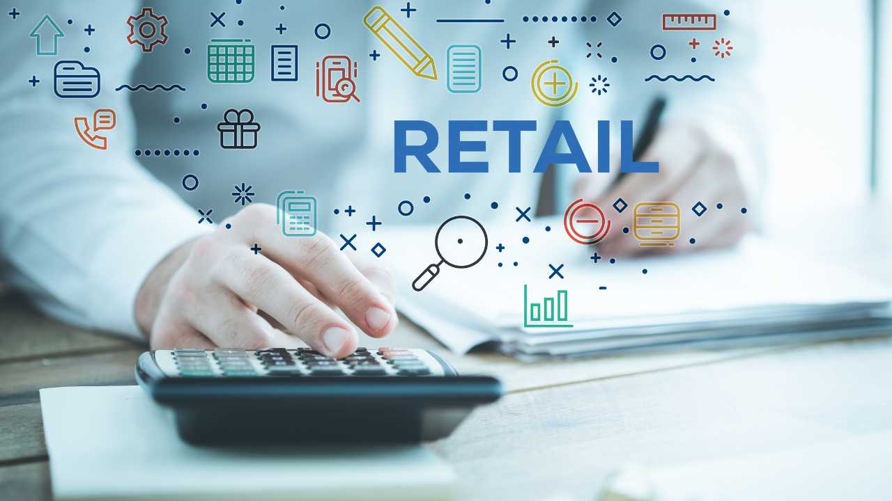 A person using a calculator with retail icons and symbols floating above