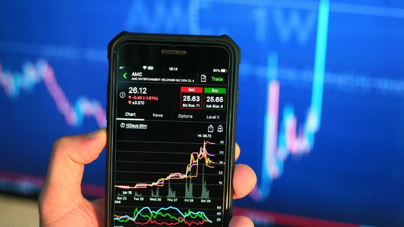 A smartphone displaying a stock trading application with market charts and data