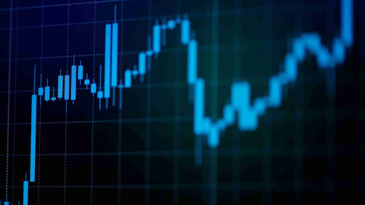 A trading monitor adorned with blue coloured candlestick patterns