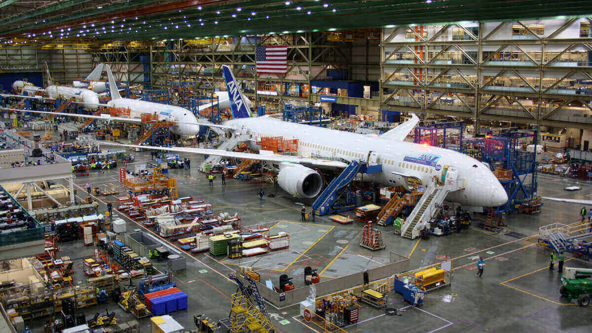 Boeing employees continue work building a Boeing 787 jets at its Everett factory