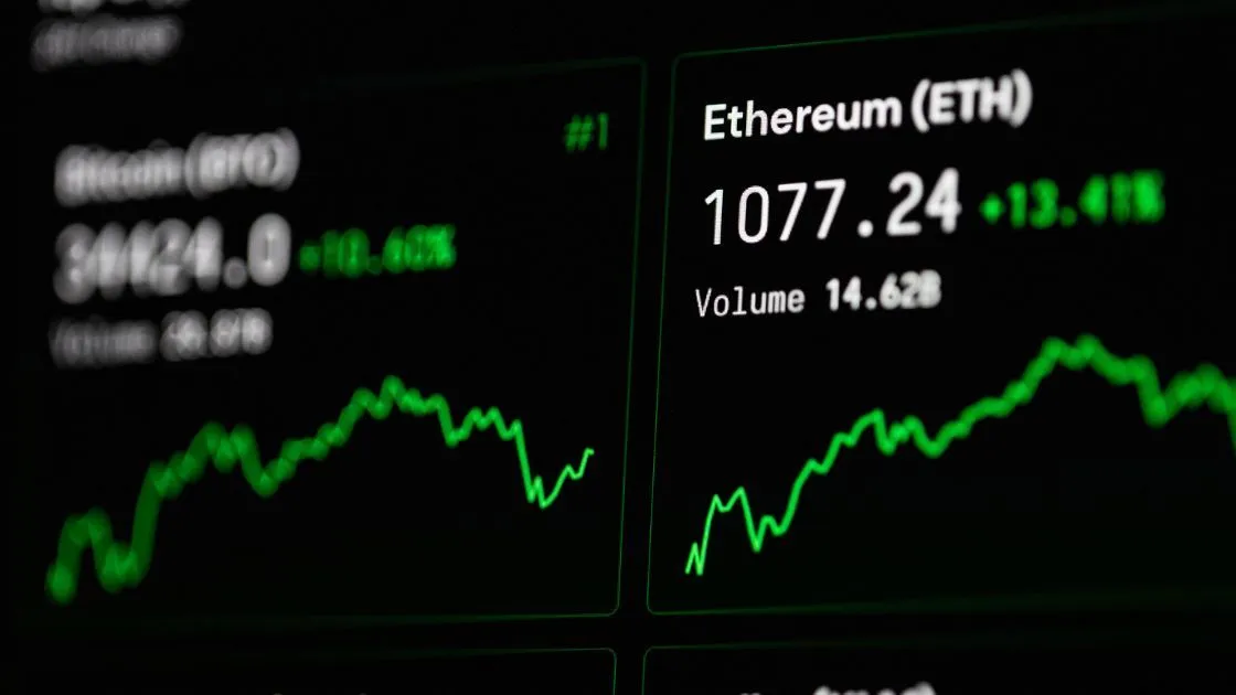 Close up view of a digital display showing cryptocurrency values with Ethereum ETH price and volume highlighted