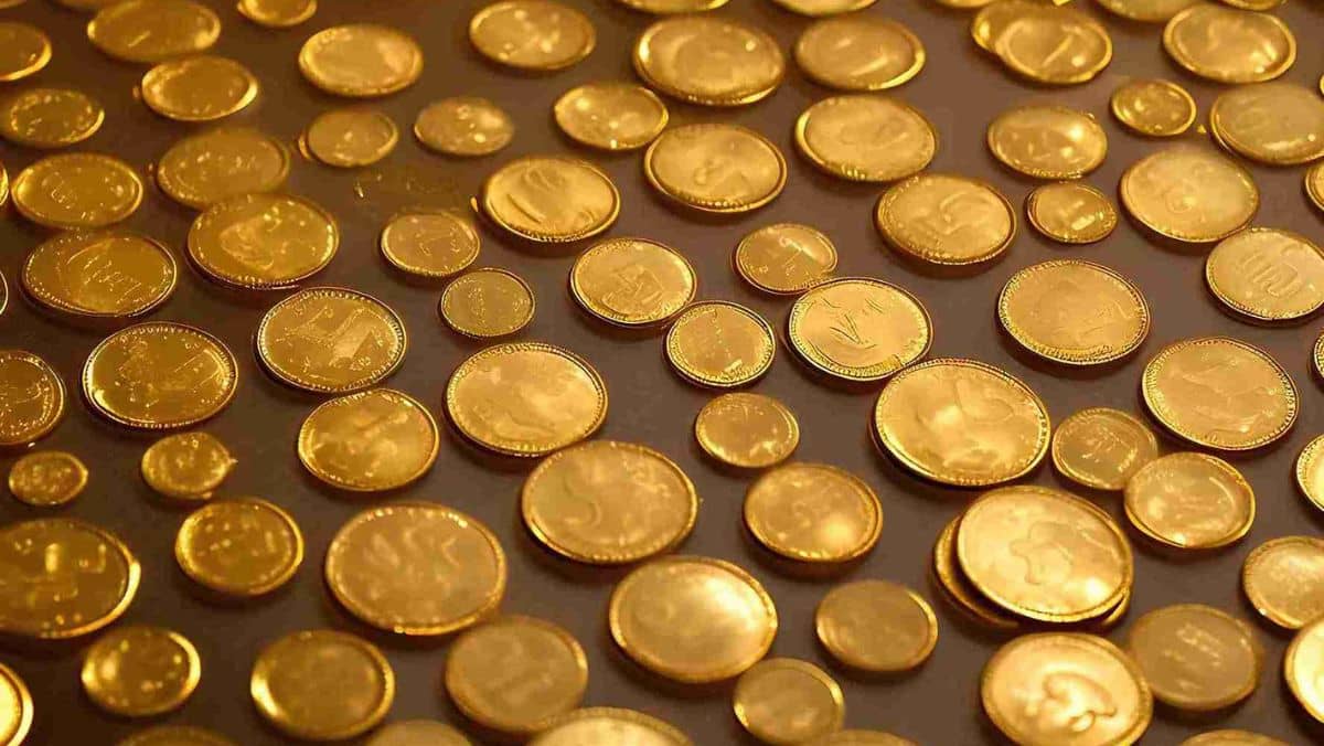 Collection of gold coins with diverse sizes laid out in an organized manner