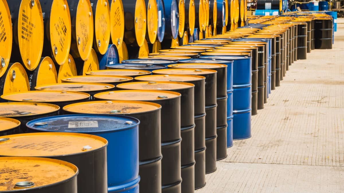 Industry oil barrels or chemical drums stacked up.container of barrels of hydrocarbons.hazardous waste of black and blue tank oil.Stack Of Oil barrels in plant