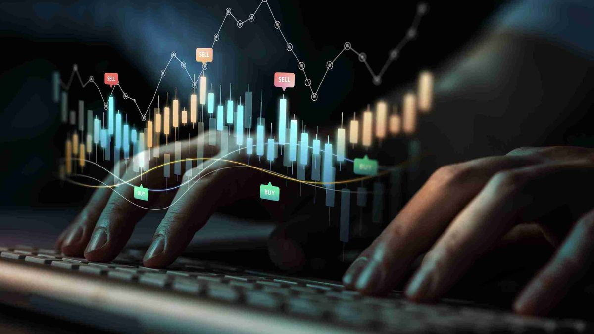 Keyboard keys being pressed while candlestick charts are being analyzed on the display