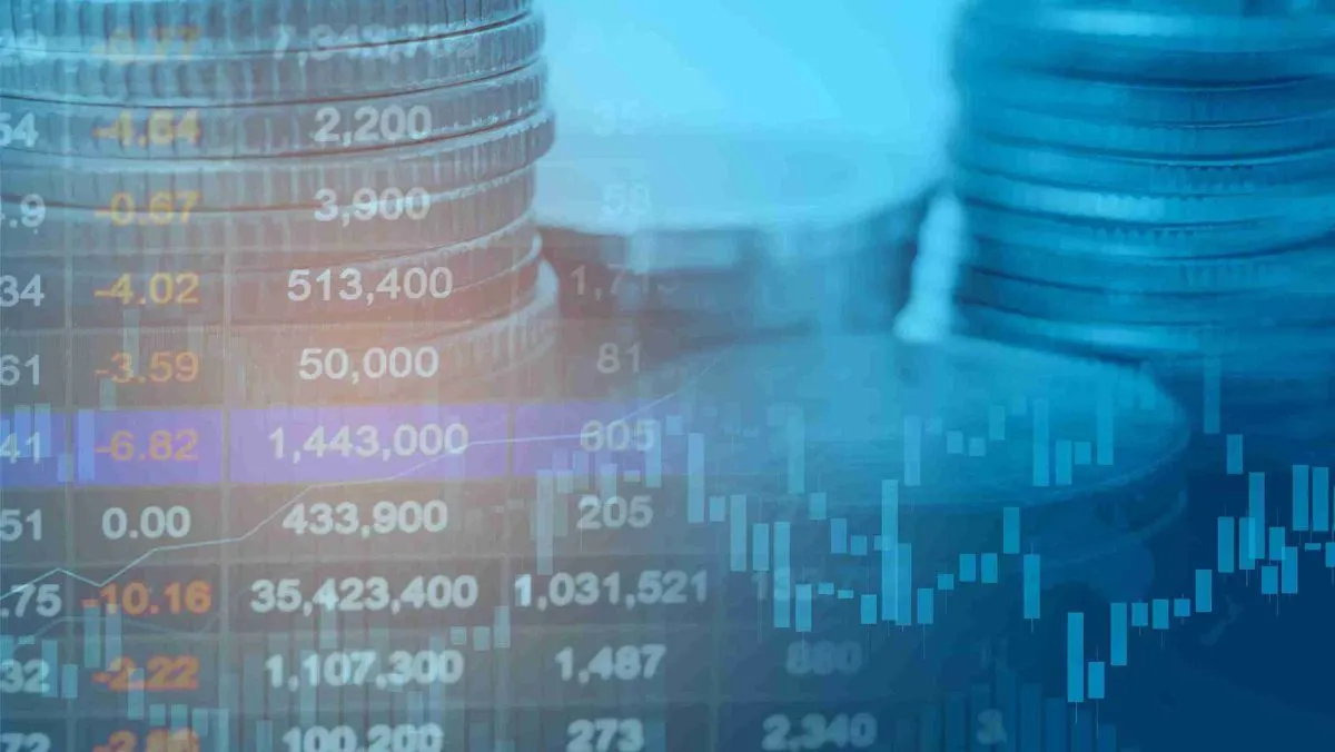 Stock market data and a stack of coins in the background