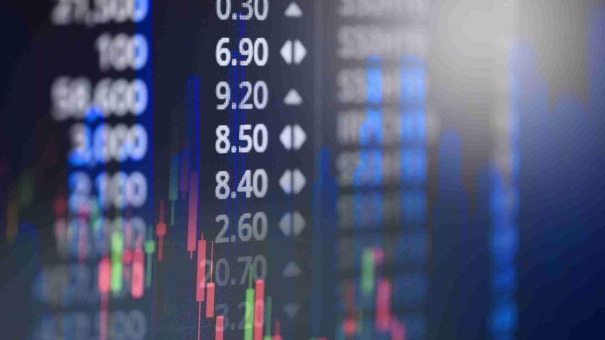 Stock market data on a digital screen and a candlestick patterns