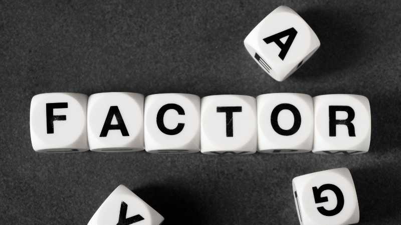 The image shows dice like cubes with letters spelling out the word FACTOR