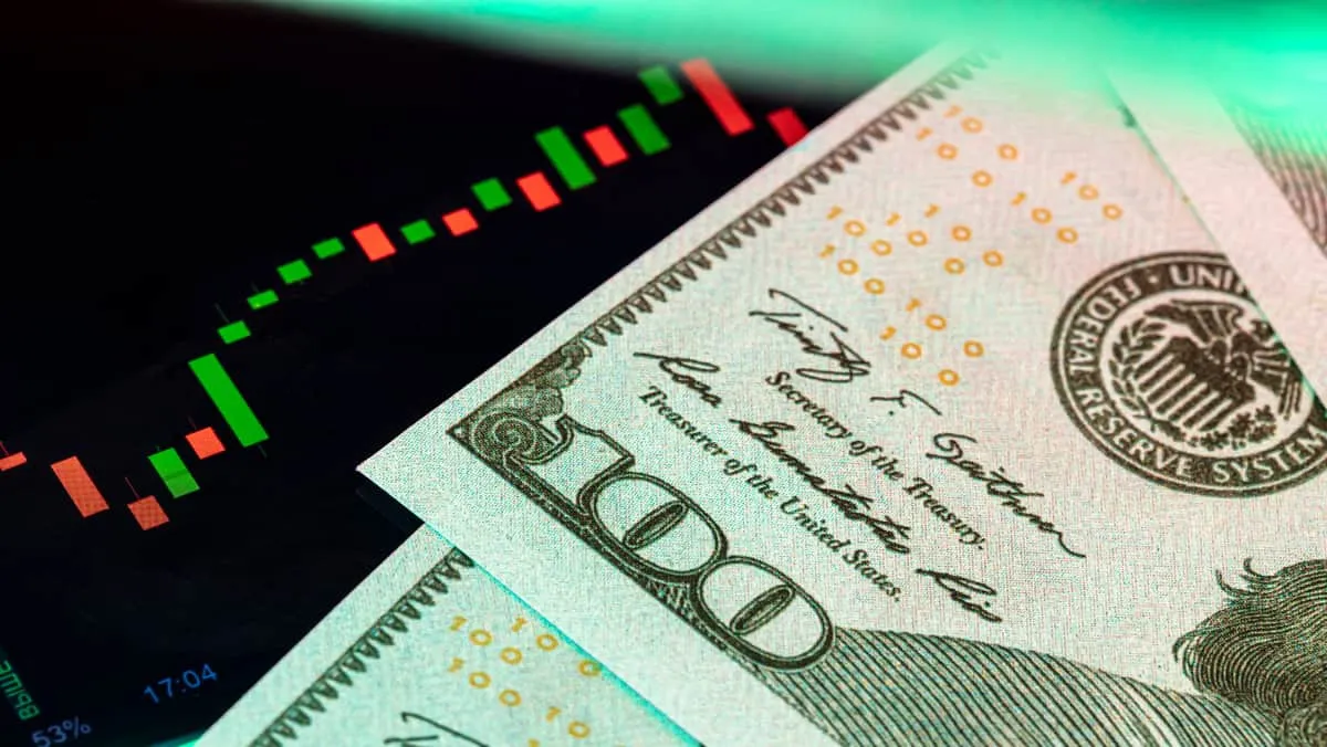 dollars-in-front-of-a-monitor-with-a-price-chart-width-1200-format-JPEG.jpg