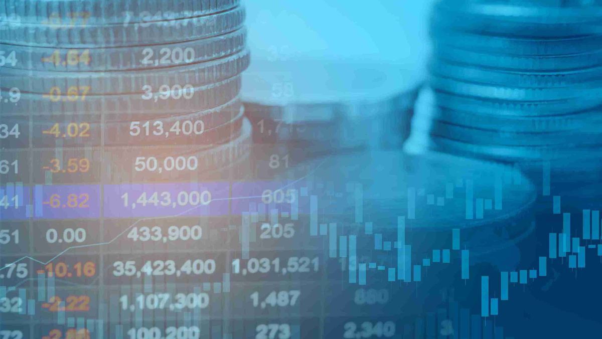 forex market data and a stack of coins in the background