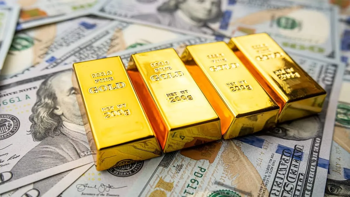gold-bars-laid-on-a-bunch-of-dollars-width-1200-format-jpeg.jpg